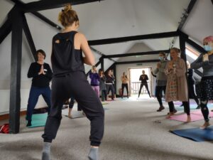 Yoga teachers practise a class