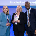 2 women and 1 man in formal attire at an awards ceremony