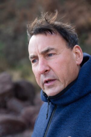 Richard wearing blue top looking pensive